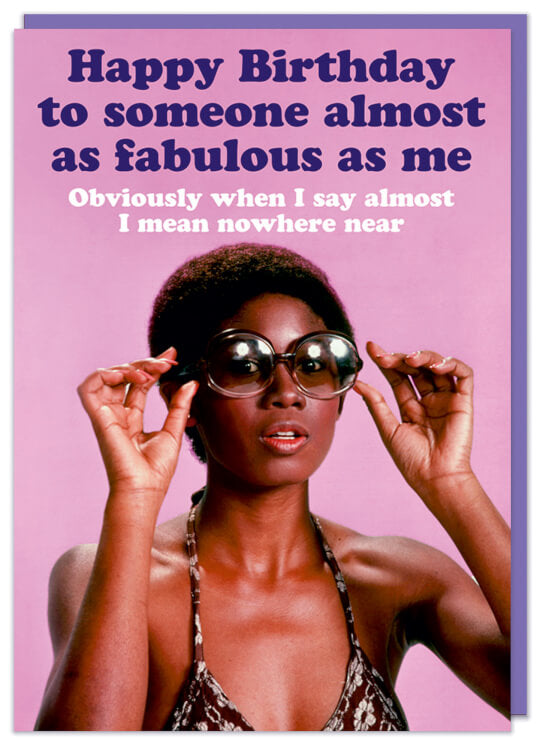 A birthday card featuring a glamourous african american woman in a swimsuit holding up a pair of sunglasses against a dark pink background