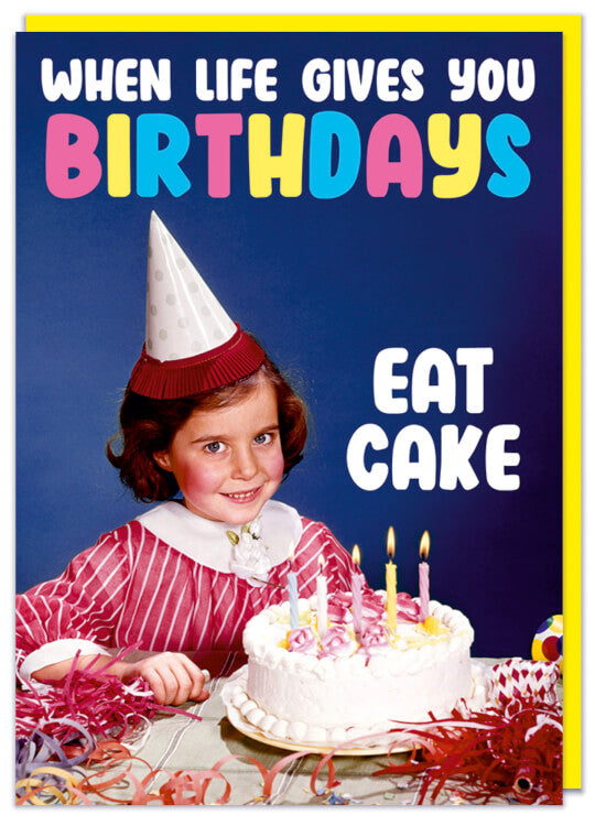 A birthday card with a picture of a smiling young dark haired girl wearing a party hat and sitting in front of a birthday cake.  White and pink, blue and yellow text reads When life gives you birthday eat cake