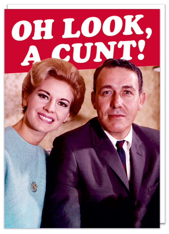 A very rude birthday card featuring a smart looking couple looking directly to camera.  A red banner with white text above them reads Oh look, a cunt