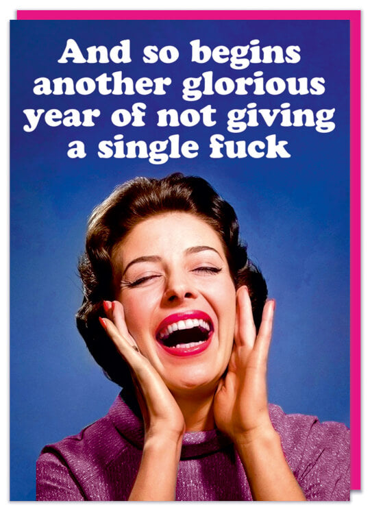 A funny rude birthday card featuring an ecstatic woman looking upwards at text that reads And so begins another glorious year of not giving a single fuck