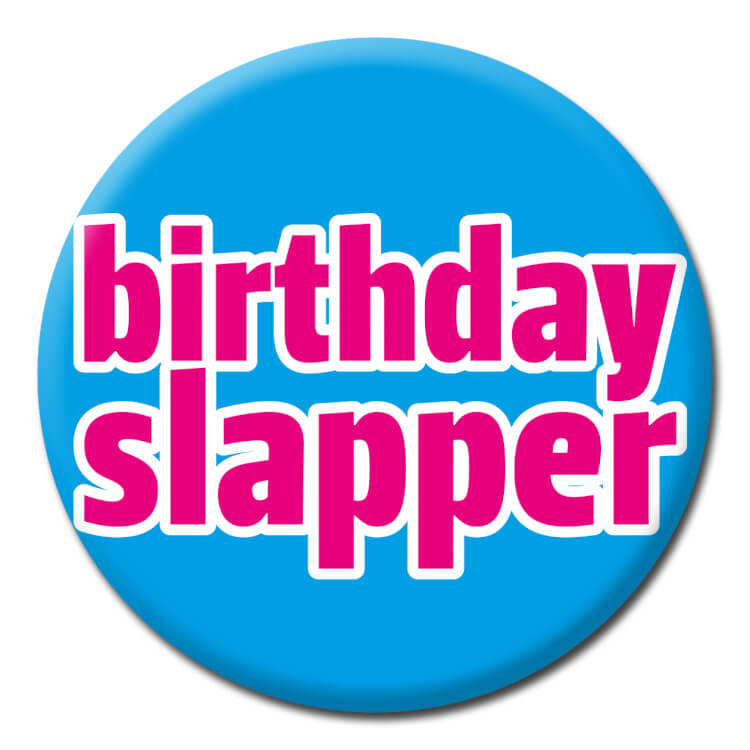 A bright blue badge with lowercase pink text with a white outline that reads Birthday slapper