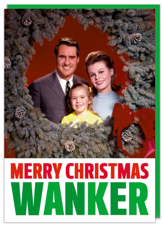 A Christmas card with a 1960s picture of a smiling family looking at camera through a festive wreath