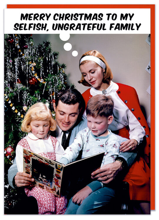 A Christmas card with a 1960s picture of a family in front of a Christmas tree