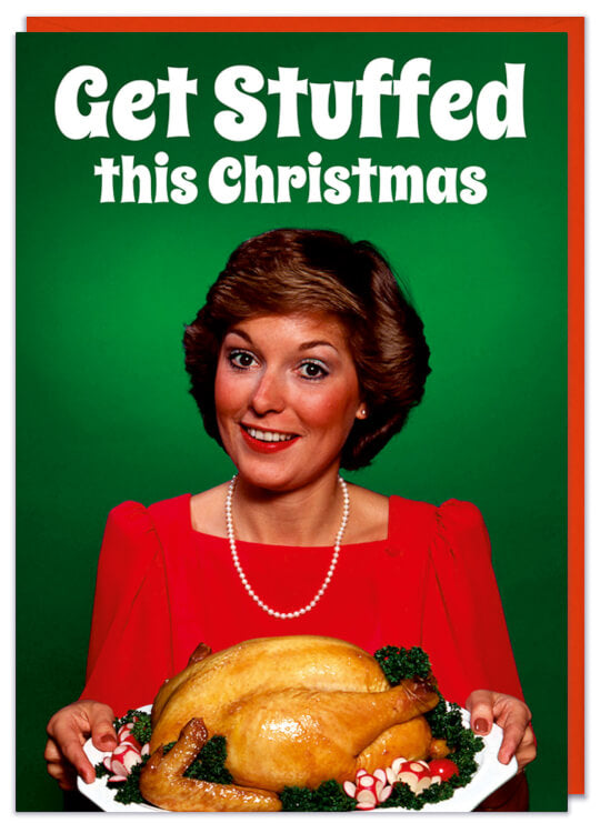 A Christmas Card with a picture of a smiling woman holding a big roast turkey