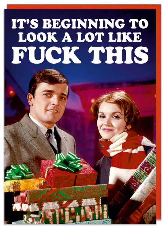A Christmas card with a 1960s picture of a smiling couple holding christmas presents