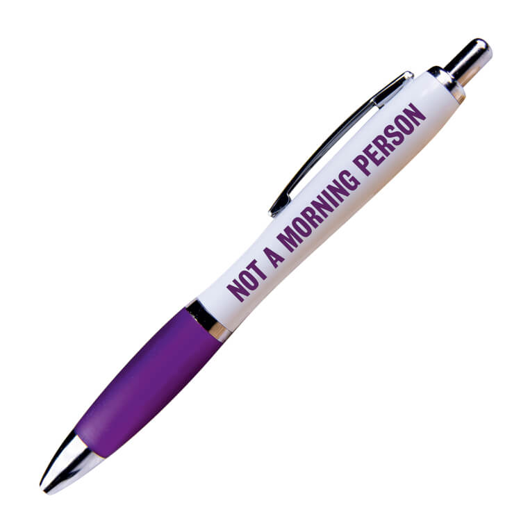 A white ballpoint pen with a purple grip and black ink. Purple text on one side reads Not a morning person