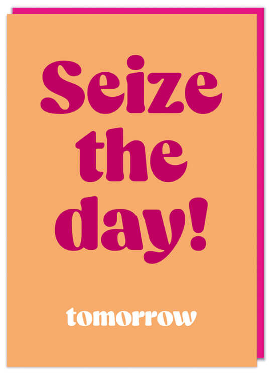 A plain pale orange greeting card with bold pink text in the middle that reads Seize the day!  Underneath smaller white text reads Tomorrow