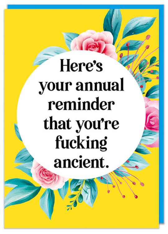 A funny rude birthday card with a flowery patter on a yellow background.  Black formal text in a white circle at the front reads Here's your annual reminder that you're fucking ancient