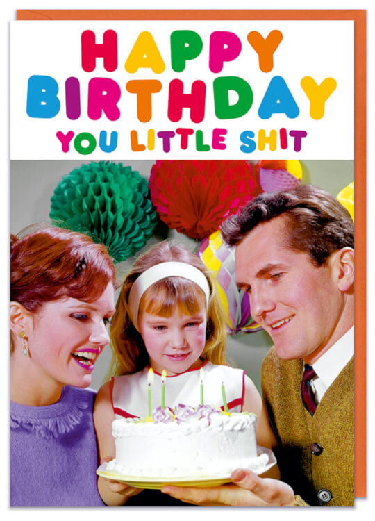 A birthday card with a retro photo of a young girl being presented a birthday cake by both her parents