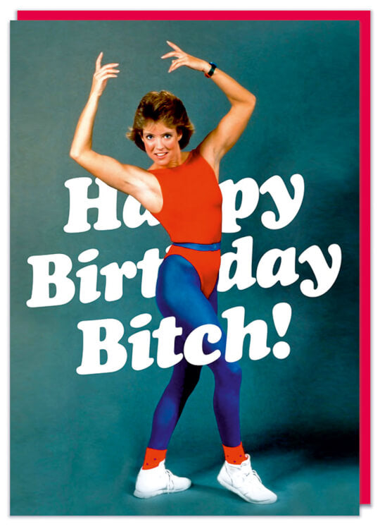 A funny birthday card featuring a retro picture of a smiling woman posing in red and blue spandex gear.  White slanted text which sits in front and behind her reads Happy Birthday bitch