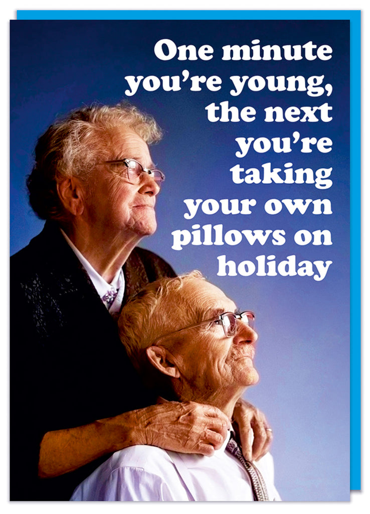 A funny retro birthday card featuring an elderly man and woman looking away into the distance against a dark blue background.  White rounded text beside them reads One minute you're young, the next you're taking your own pillows on holiday