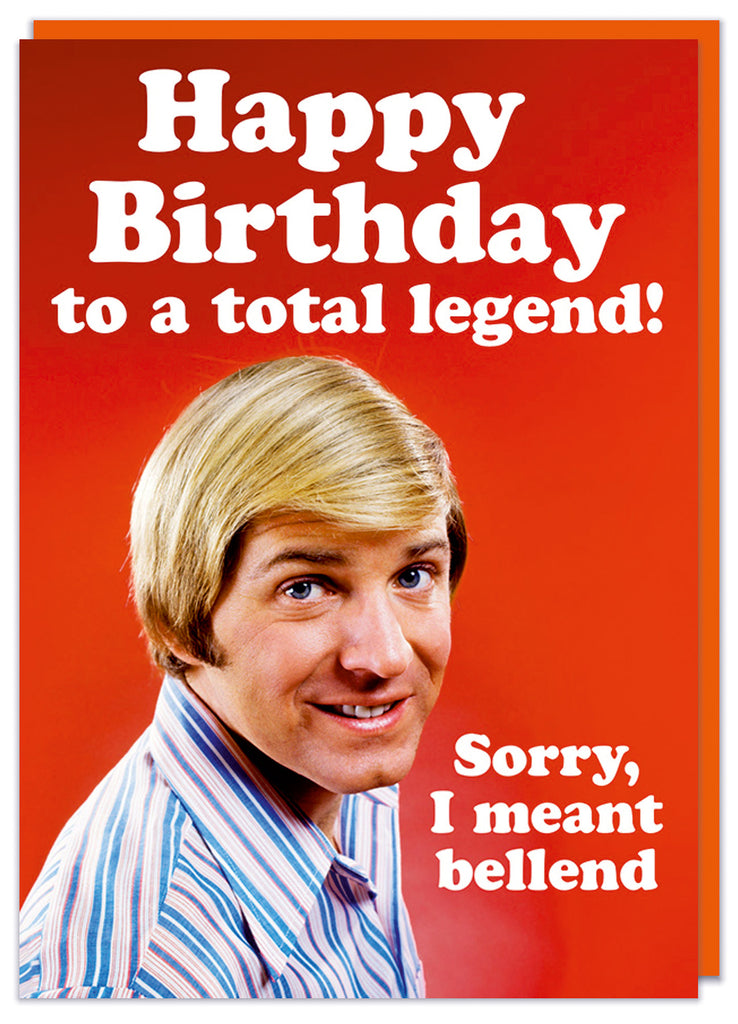 A funny birthday card featuring a 1960s photo of a smiling blond haired man looking to camera against a red background.  Bold white text above and beside him reads Happy Birthday to a total legend. sorry, I meant bellend