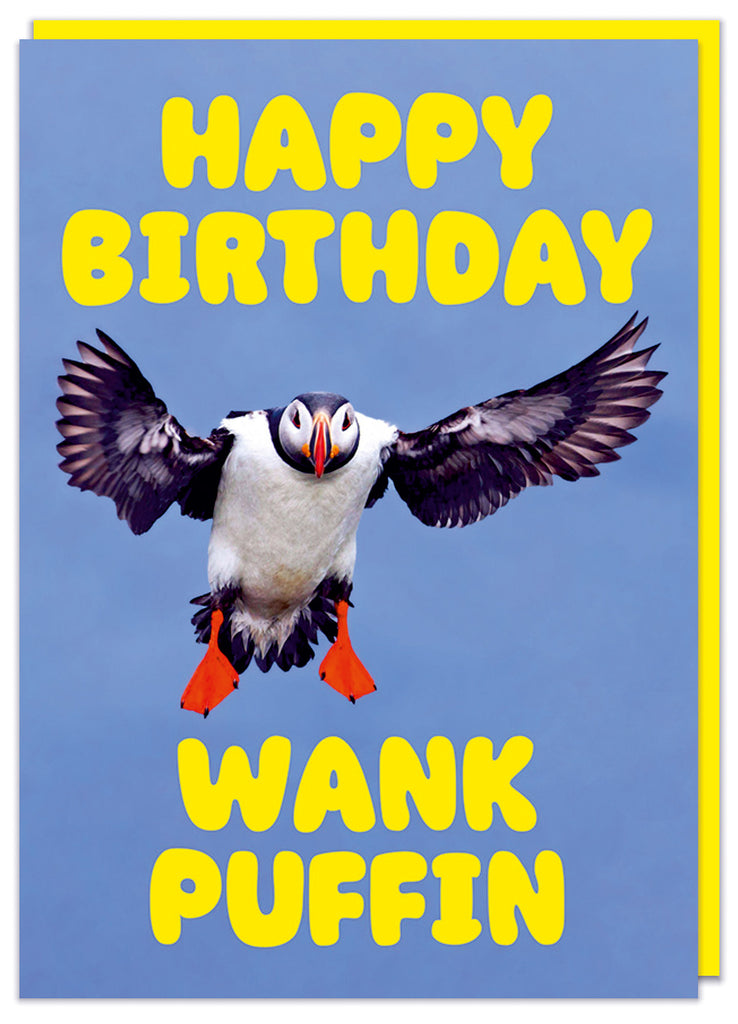 A funny and rude birthday card with a picture of a puffin in mid flight looking to camera. Rounded bold yellow text above and below reads Happy birthday wank puffin