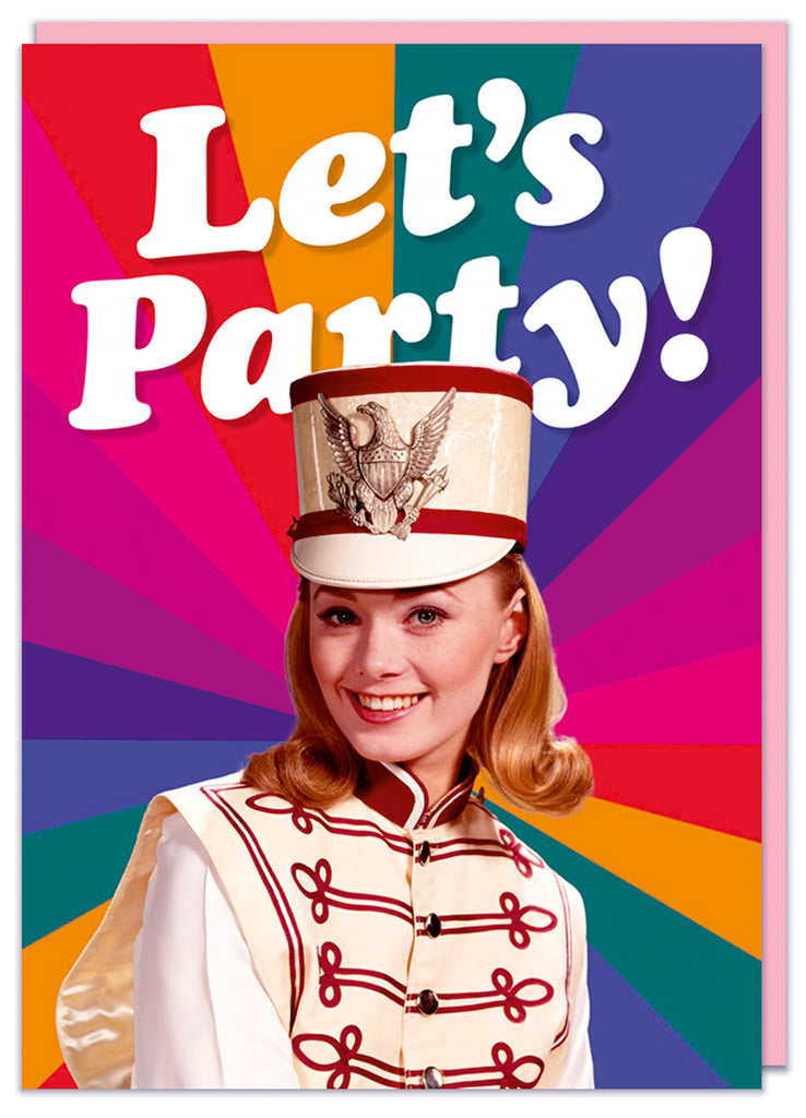 A funny birthday card featuring a retro picture of a smiling young woman in a majorette outfit in front of a rainbow starburst pattern