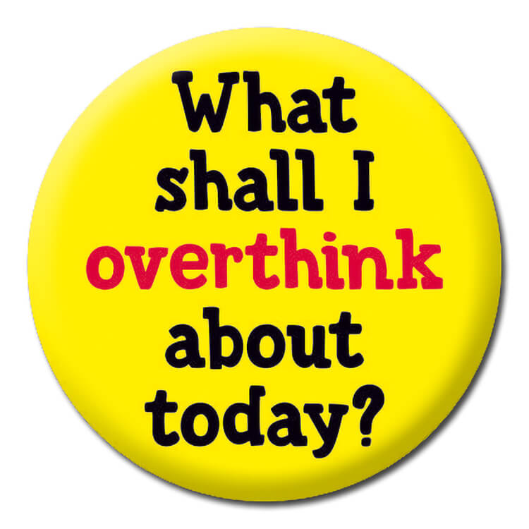 A bright yellow badge with bold lower case red and black text that reads What shall I overthink about today