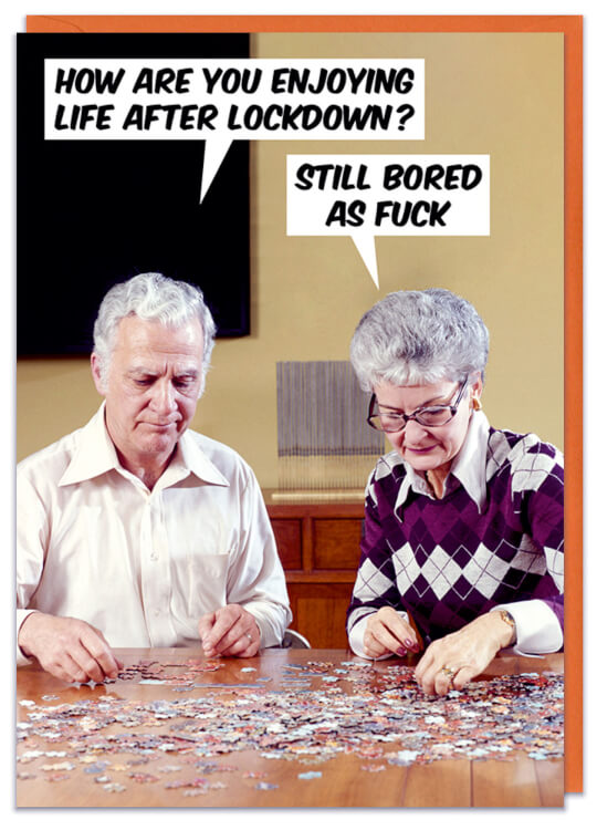 A birthday card with a photo of an old man and woman playing a jigsaw puzzle