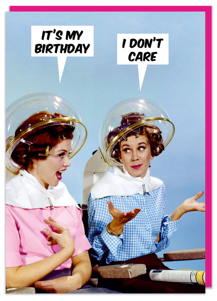 A funny retro birthday card featuring two young women both sitting in a hair parlour with their heads under dryers.  One says It's my birthday to which the other replies I don't care