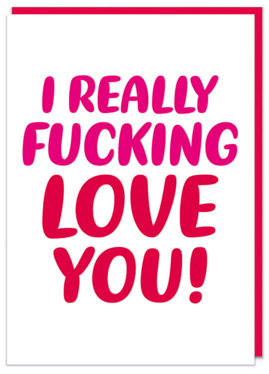 A white Valentine's Card featuring rounded red and pink text in the middle that reads I really fucking love you