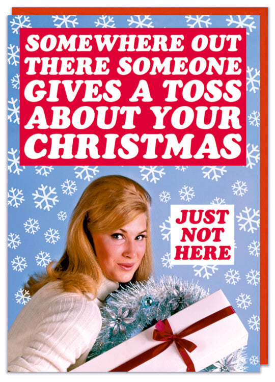 A Christmas card with a 1970s picture of a smiling young woman holding Christmas presents