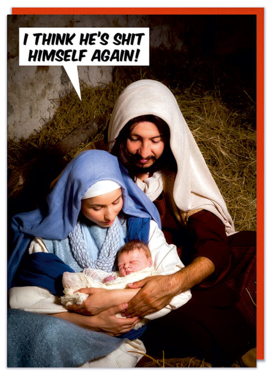 A Christmas card with a staged photo of Joseph and Mary cradling baby Jesus in a stable