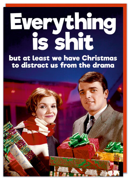 A Christmas card featuring a retro picture of a man and woman adorned with lots of Christmas presents