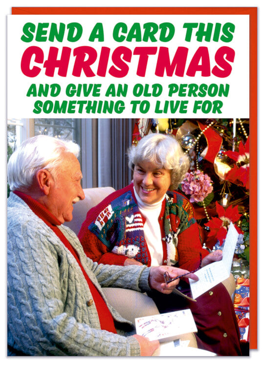 A Christmas card with an 80s picture of an old couple smiling as they open a Christmas card
