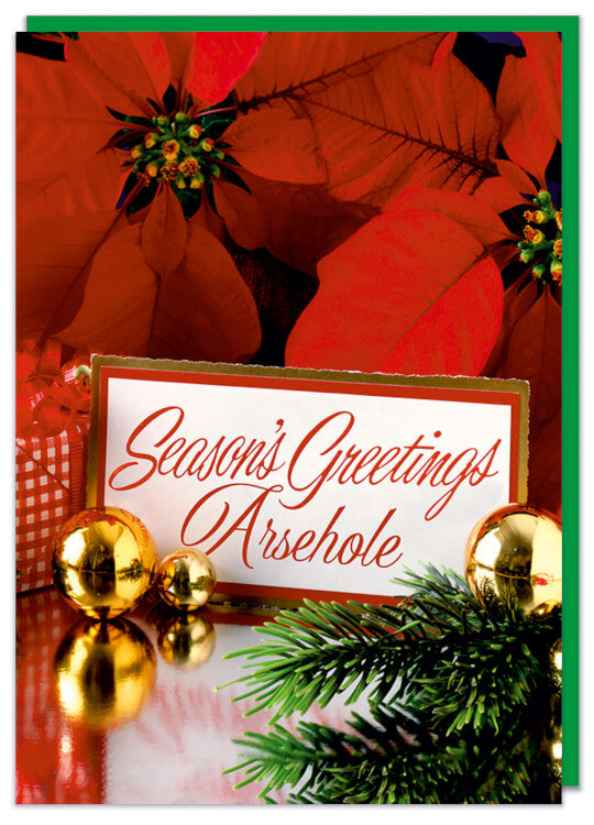 A blue Christmas card with a 1970s picture of a festive floral scene featuring baubels, pine leaves and poinsettias