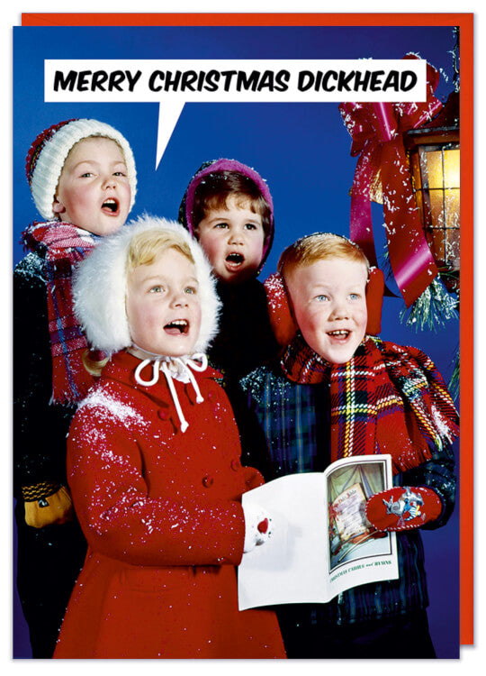 A Christmas card with a retro picture of four young carol singers.  They are collectively saying Merry Christmas dickhead