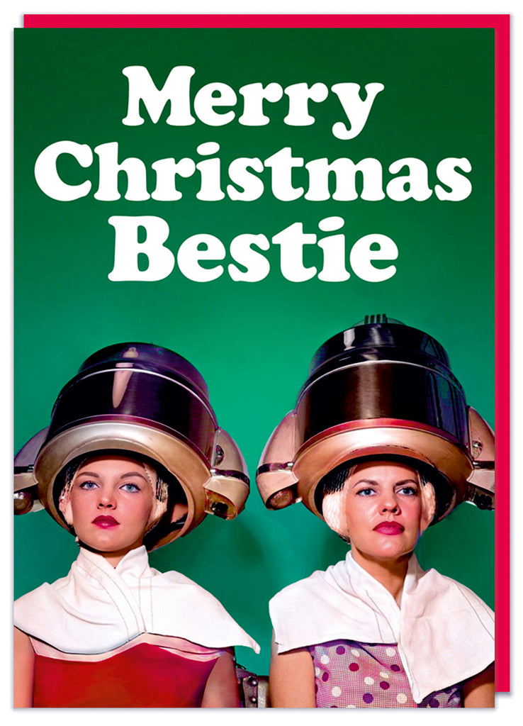 A Christmas card with a vintage photo of two young women both sitting looking forward with their hair in commercial hair dryers.  White rounded text above reads Merry Christmas Bestie
