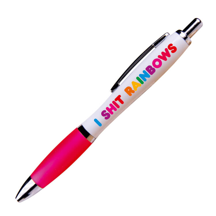 A white ballpoint pen with a pink grip and black ink.  Rainbow text reads I shit rainbows.