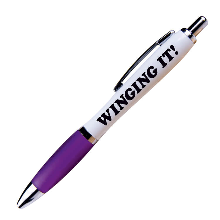 A white ballpoint pen with a purple grip and black ink. Black text on one side reads Winging it!
