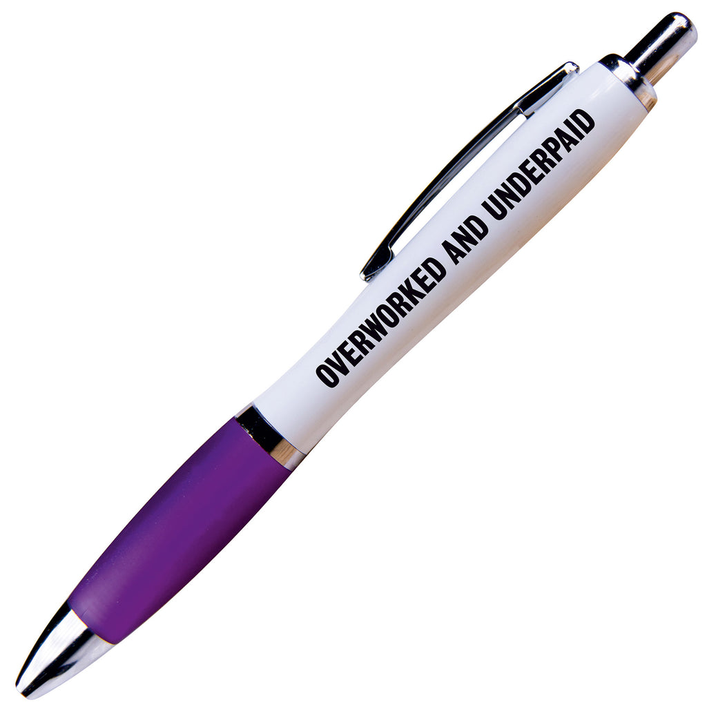 A white ballpoint pen with a purple grip and black ink. Black text reads Overworked and underpaid