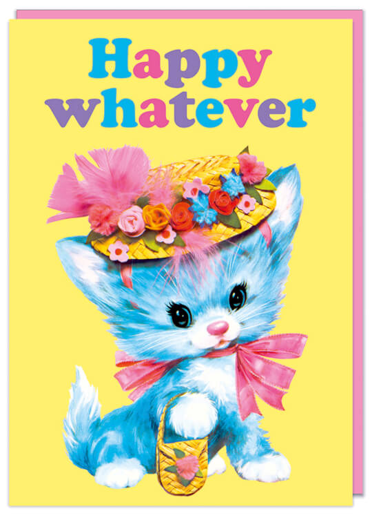 A birthday card with a kitsch illustration of of a blue kitten with a bonnet and little handbag against a yellow background.  Rounded blue, pink and purple text above reads Happy Whatever